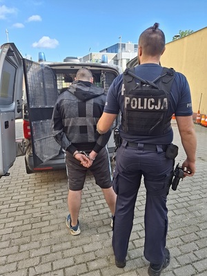 policjant podczas doprowadzenia